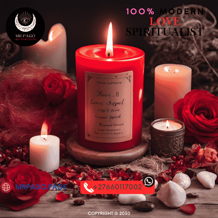 A burning red candle surrounded by love spell ingredients.