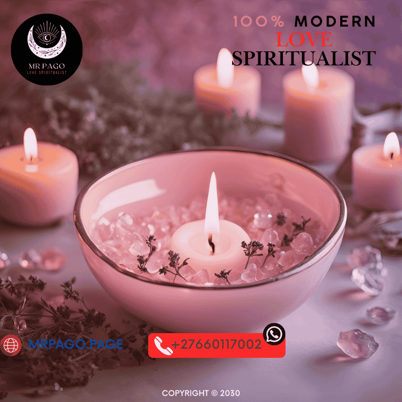 A pink candle burning in a love spell ritual with rose petals and quartz crystals.